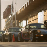 line of Porsche cars on racetrack