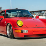 Red Porsche 911 parked on road