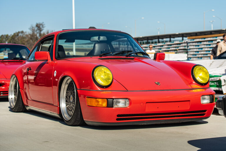 Red Porsche 911 parked on road