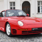 Red Porsche 959 on brick road