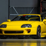 yellow Toyota supra in garage