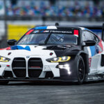 bmw m4 with racing livery driving on a race track