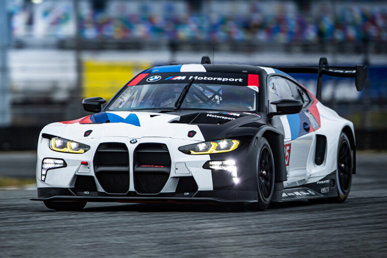 bmw m4 with racing livery driving on a race track