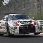 white nismo super gt-rleaping through air
