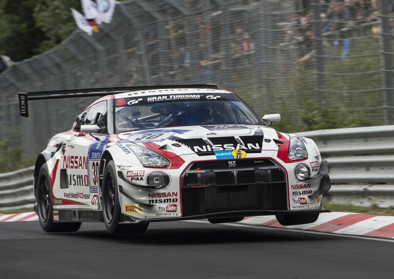 white nismo super gt-rleaping through air