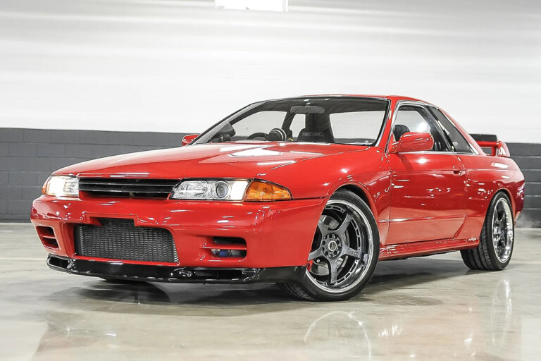 Red Nissan Skyline R32 parked in a showroom