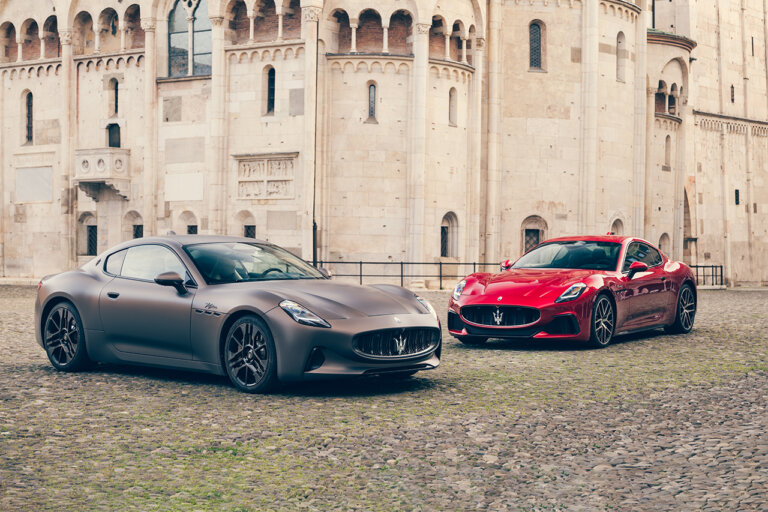 grey and red cars parked on brick road