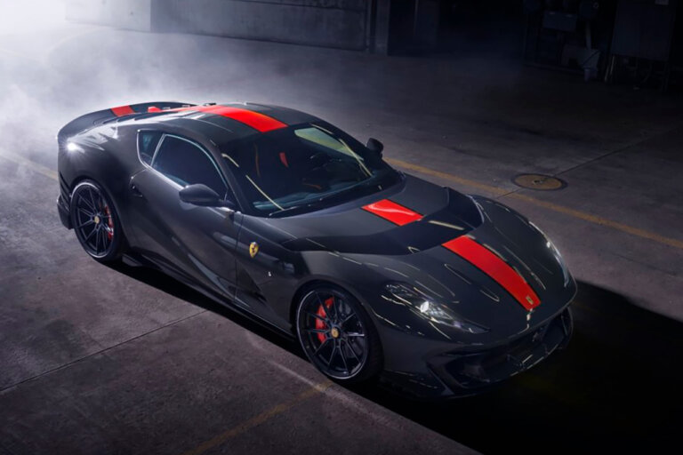 Blue grey Ferrari 812 Competizione with red stripe in a smoky garage, dark background