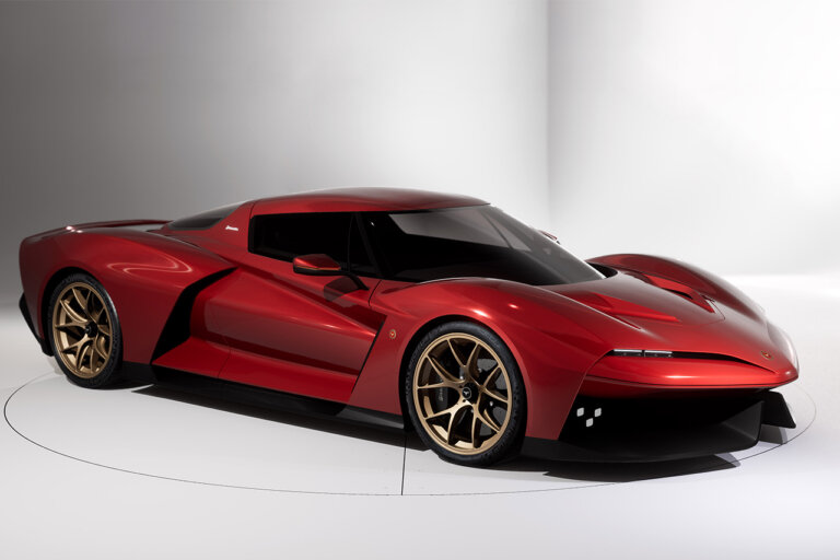 Red Bizzarrini Giotto parked over a circle and two white walls behind it