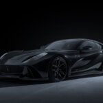 Black Novitec N-Largo S parked in a dark room with one light pointed toward the rear of the car