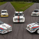 Group of cars with various liveries parked next to one another