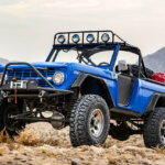 1966 blue bronco on desert rocks