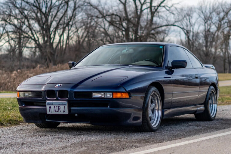 Blue BMW E31 parked on the side of the road