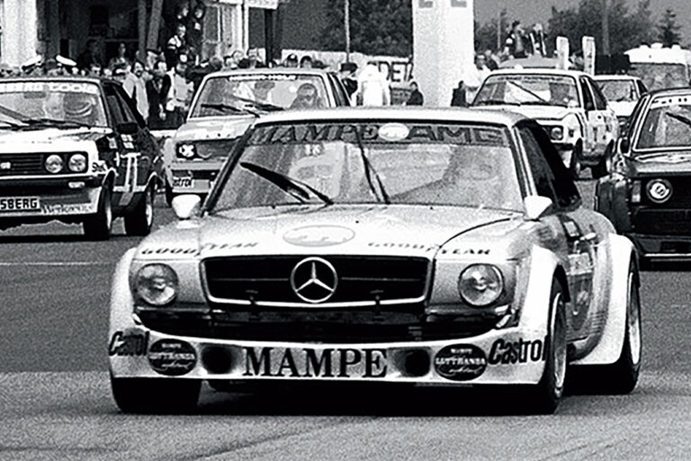 black and white photo of Mercedes 450 SLC AMG coupe in a race