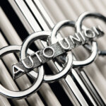 Former Audi logo that says auto union through the center with white pillars behind it