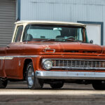 Brown Chevy C10 with white roof parked in front of a warehouse