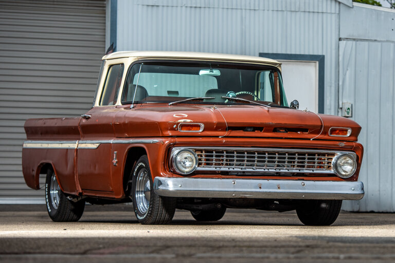Brown Chevy C10 with white roof parked in front of a warehouse