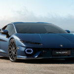 Blue Lamborghini Temerario parked on the sand with blue sky in background
