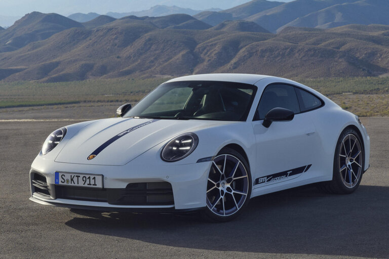 White 911 Carrera T parked at an angle with mountains in the background