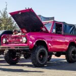 hot pink lifted classic ford bronco with soft top at sema