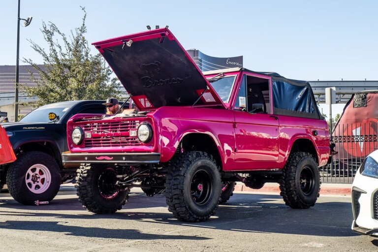 hot pink lifted classic ford bronco with soft top at sema