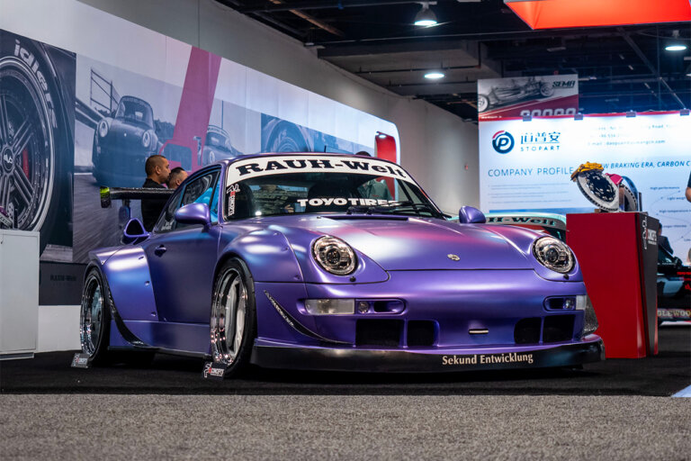 Purple Porsche RWB 993 911 at Shandong Stopart brake materials booth during the SEMA 2024 event.