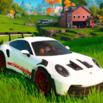 White Porsche 911 GT3 RS parked in the game Fortnite with grass landscape with barn in the background.