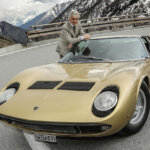marcello gandini with a gold lamborghini miura on a mountain road